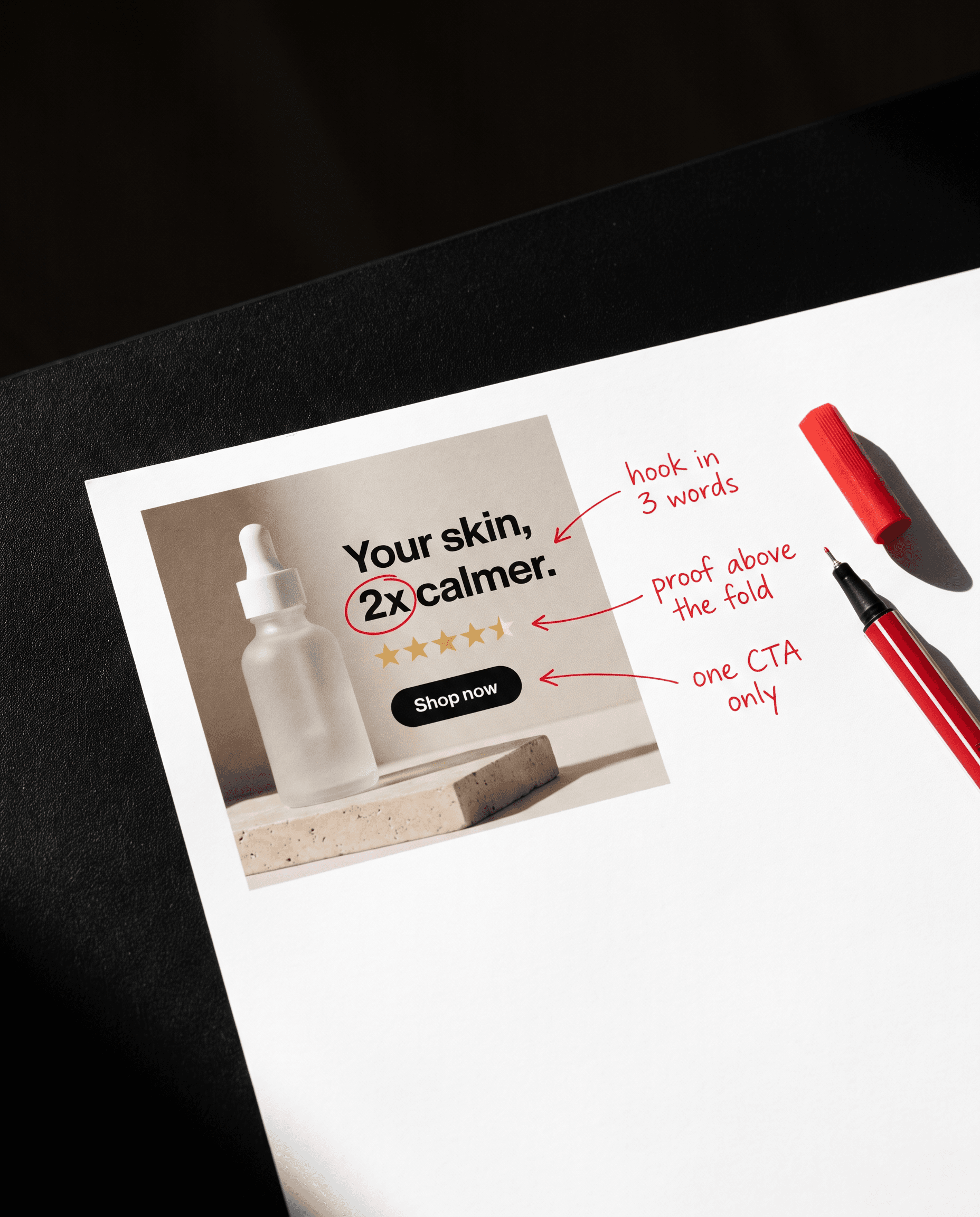 A printed ad with red handwritten notes: hook in 3 words, proof above the fold, one CTA only
