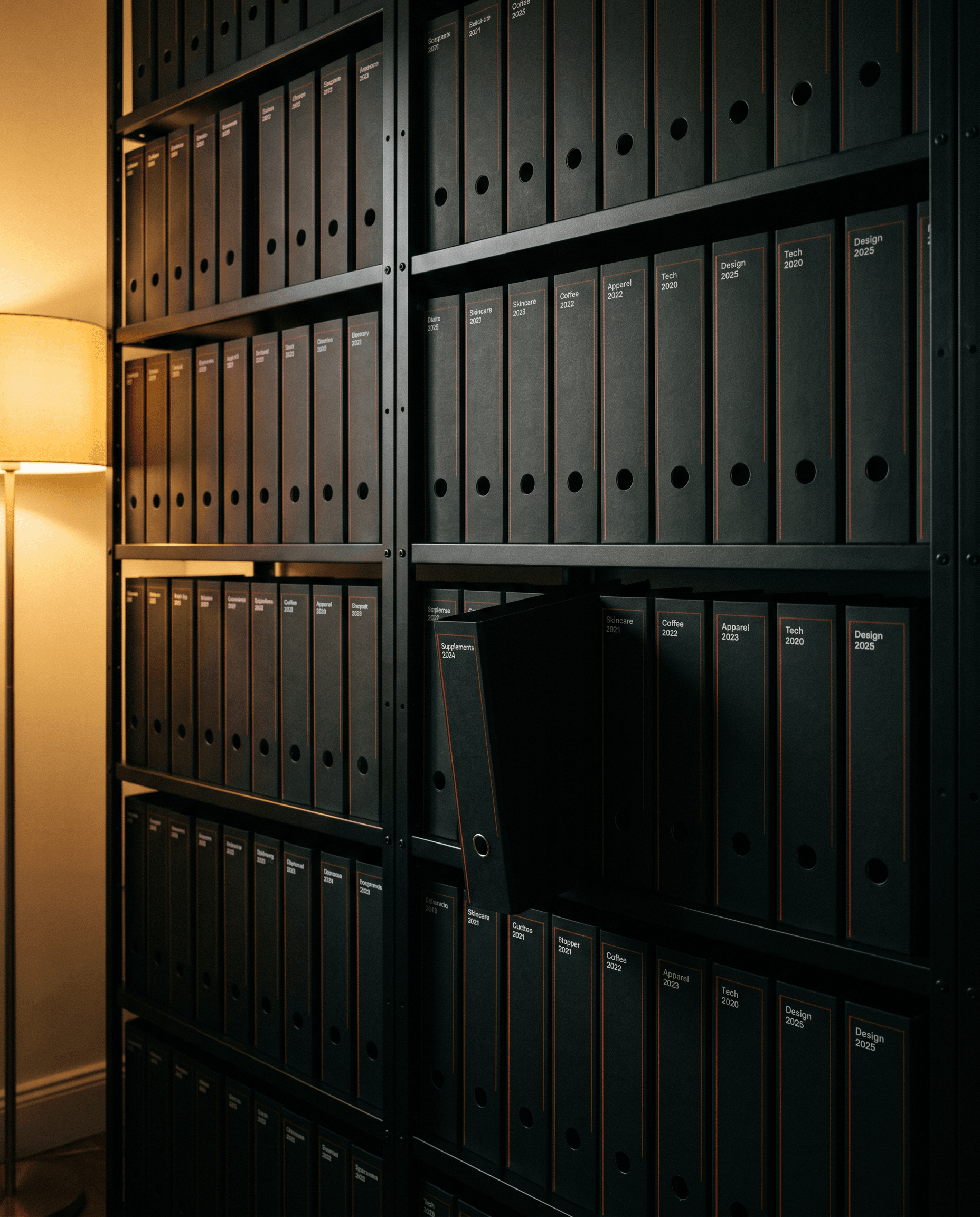 Shelves of black client archive binders, one pulled out
